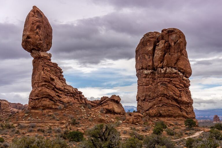 Gigantic boulder perched on top of other boulders looking as though it might fall