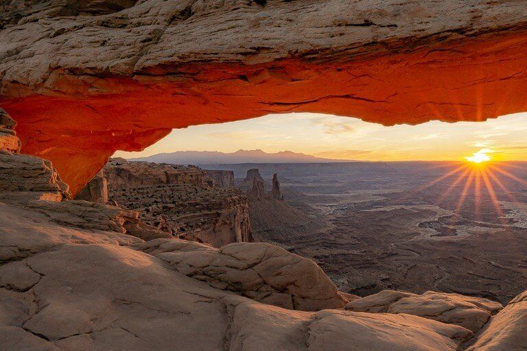 Sunrise with sunburst over canyonlands national park mesa arch one day in arches and Canyonlands national parks Utah