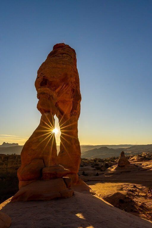Delicate Arch sunburst just before twilight in Utah National Park Mighty 5