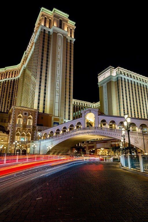 The Venetian Hotel in Las Vegas Lit up at night and car lights long exposure Utah road trip