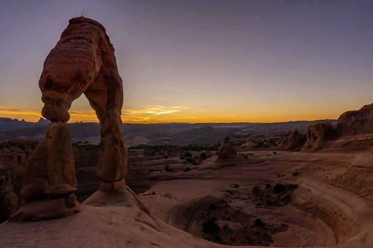 Famous sandstone arch formation at sunset with a purple sky