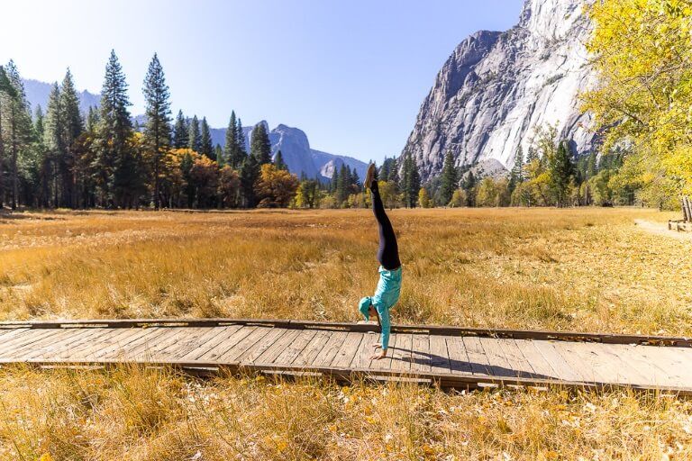 Kristen doing a perfect handstand in Yosemite Valley meadow gorgeous fall colors