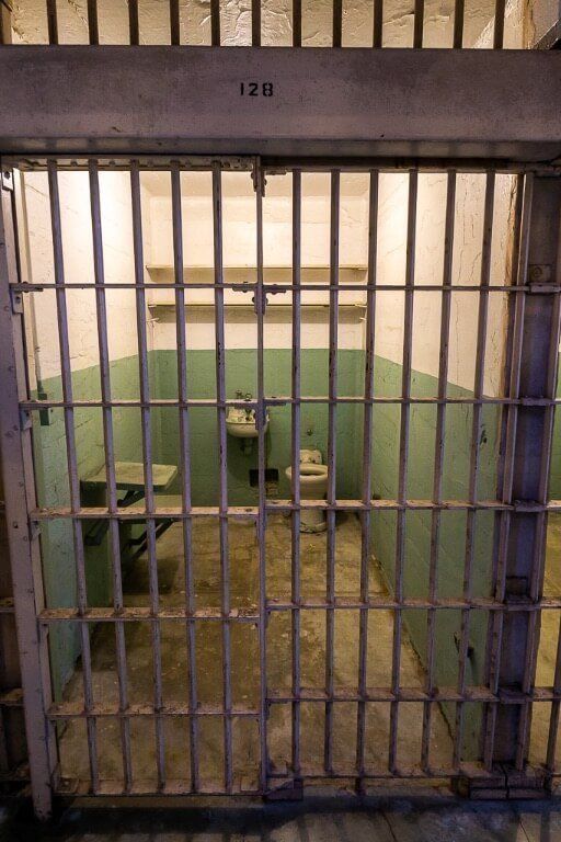 Inside of an Alcatraz prison cell with bed toilet and sink