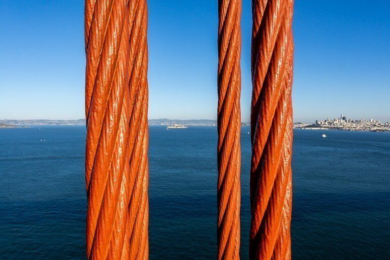 Alcatraz and San Francisco between cables on bridge