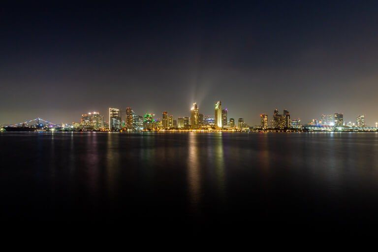 San Diego skyline and USS Midway from Centennial Park Coronado lit up across San Diego bay three day itinerary San Diego first time visitors