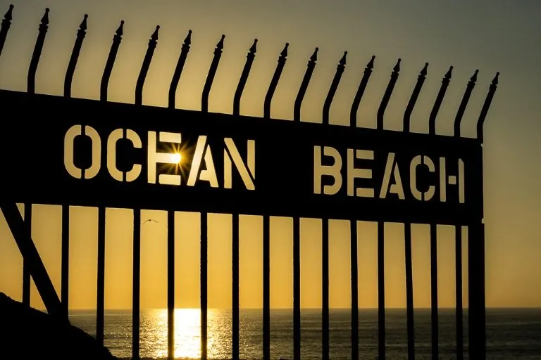 Ocean Beach sign with sunburst close to sunset in San Diego