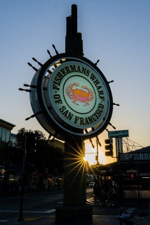 Explore touristy fisherman's wharf as part of your first time visit to San Francisco itinerary sign lit up and sunburst