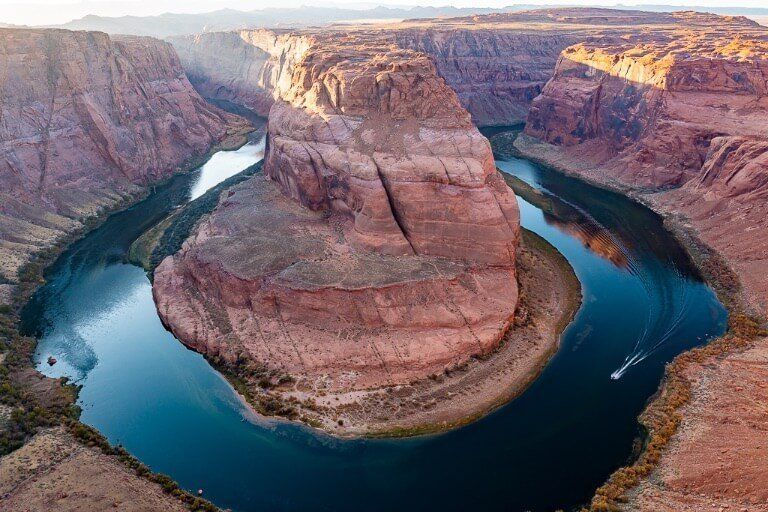 Awesome reflection on Colorado River with speedboat at Horseshoe Bend AZ
