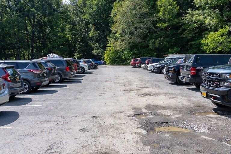 upper entrance overflow parking lot with many cars 