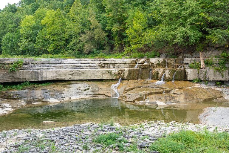 Small shelf like waterfall running dry near the entrance to an Ithaca state park in the finger lakes