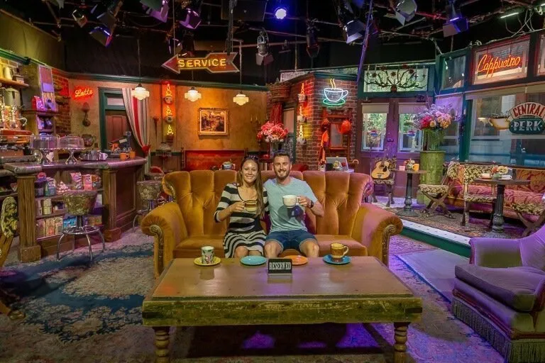 Mark and Kristen sitting at the famous sofa in central perk from friends tv show