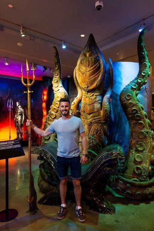 Mark holding Arthur curry's trident from aqua man at Warner Bros studio tour in Hollywood Los Angeles