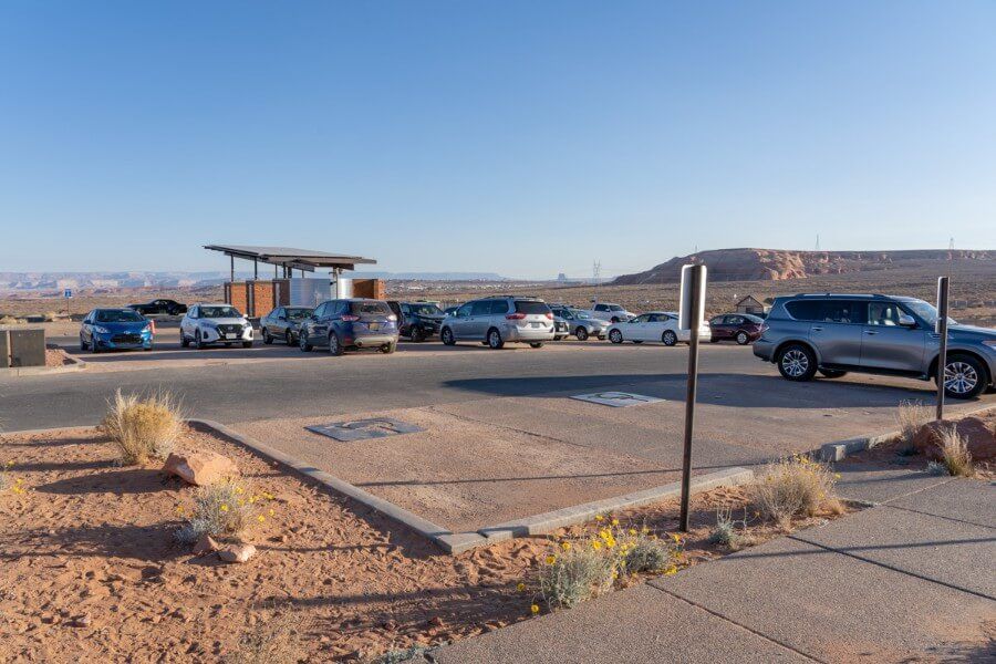 Horseshoe Bend Arizona Parking Lot with cars right after sunrise