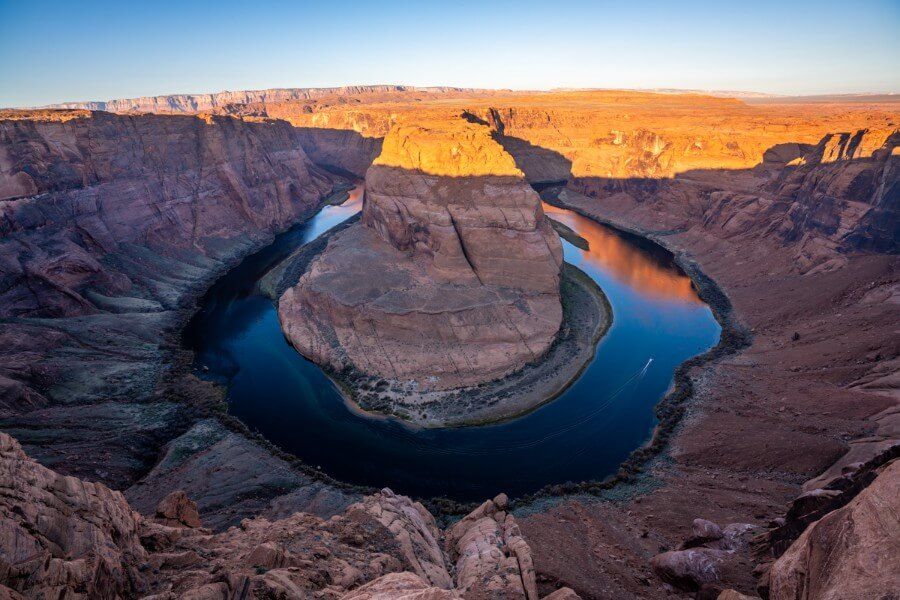 Sunrise at Horseshoe Bend with a speedboat on the Colorado River