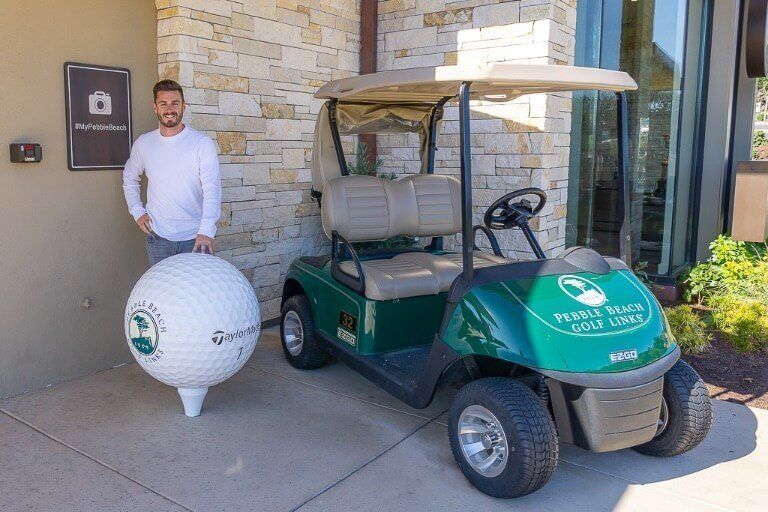 Mark at Pebble Beach golf club next to golf cart in Monterey California