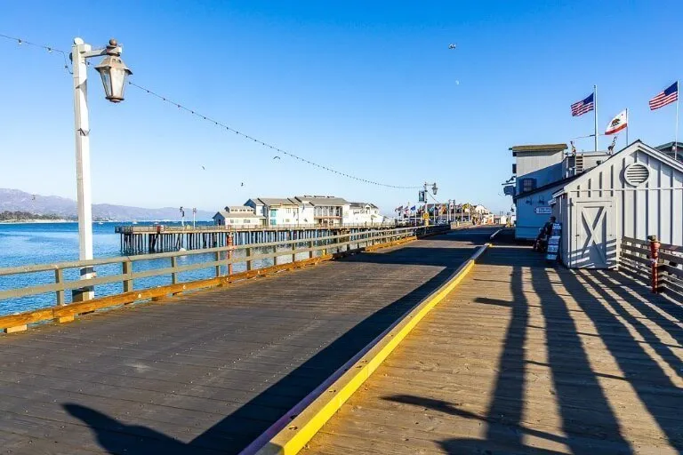 Santa Barbara Pier near sunset long shadows casting and usa flags waving in wind