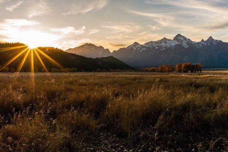 Beautiful starburst at sunset over hills and mountains in Fall