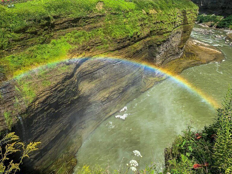 Rainbow in a gorge with high walls and river in new york
