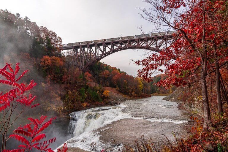 Letchworth State Park upper falls train crossing train bridge beautiful red colors in fall
