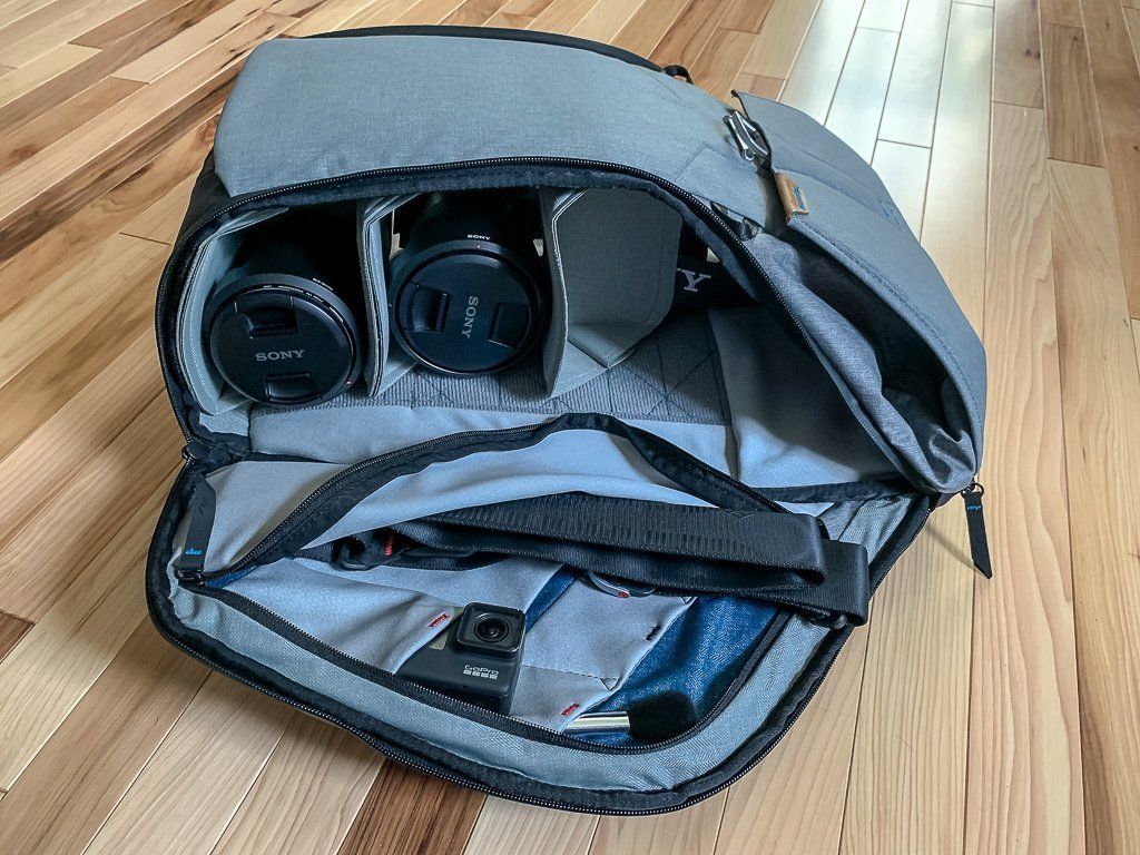 Camera backpack showing what can fit inside compartments