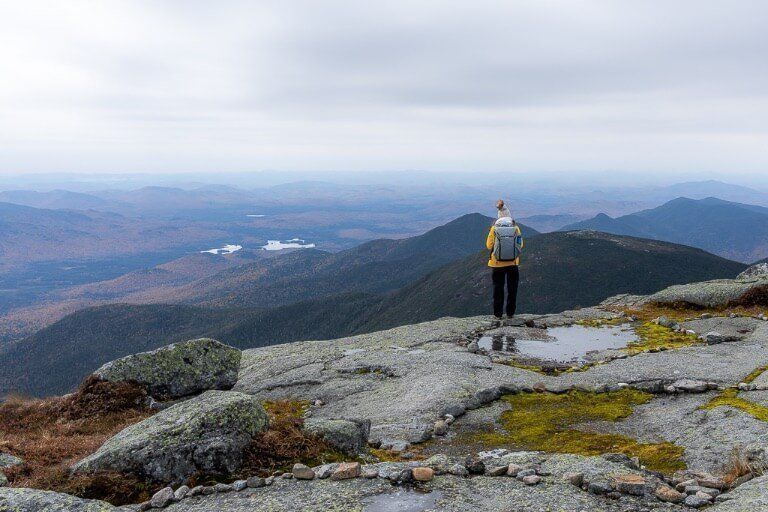 Kristen at Mount Marcy summit in New York Adirondacks with peak design everyday backpack
