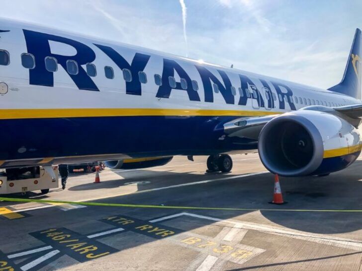 Ryanair plane close up of name sat at a gate in an airport one of the most popular airlines to use to book cheap flights in Europe