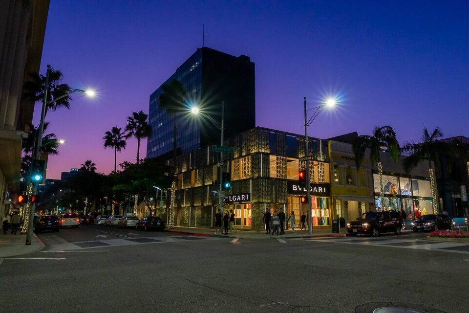 Beverly Hills Los Angeles California at night purple sky behind high end shopping