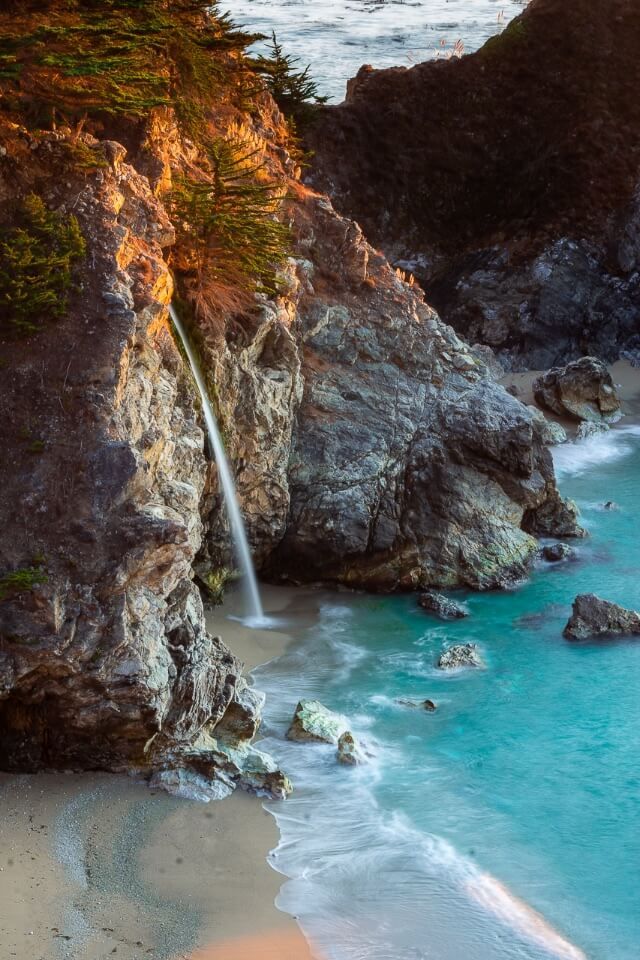 McWay Falls is one of the best stops along the california pacific coast highway stunning images of the waterfall hitting the sandy beach and turquoise water