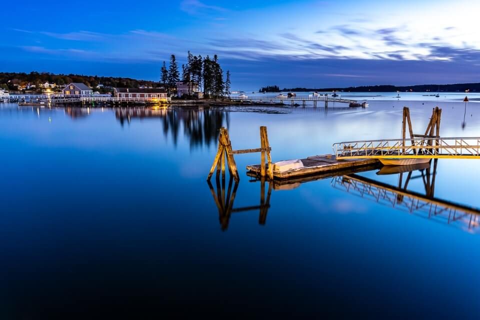 Sunset at boothbay harbor in maine usa still water with reflections of island and jetty