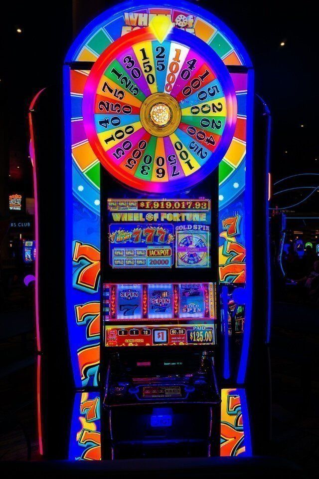 Wheel of fortune slot machine in las vegas lit up multi colors in a casino