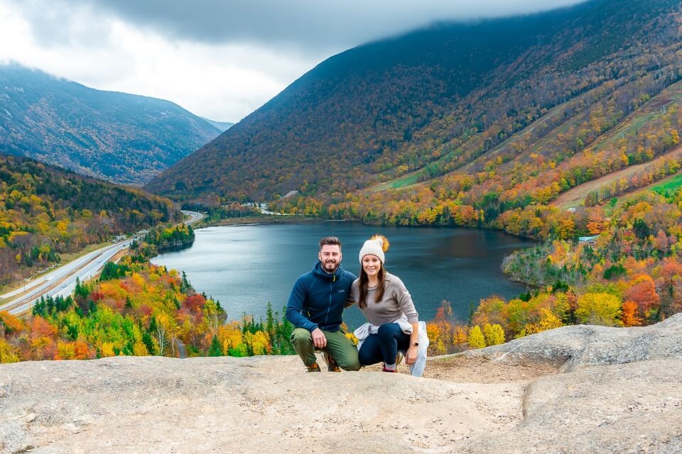 Mark and Kristen where are those morgans travel blog crouched down on artists bluff franconia notch state park new hampshire in fall with stunning colors and dark clouds pictures of america