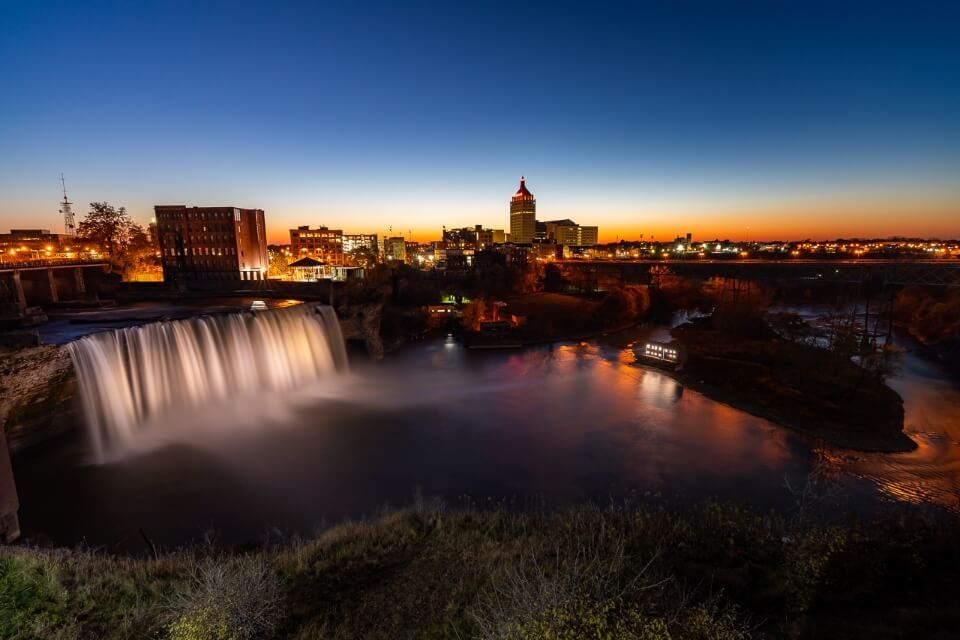 High falls in rochester new york at sunset with stunning colors in the sky and awesome waterfall illuminated