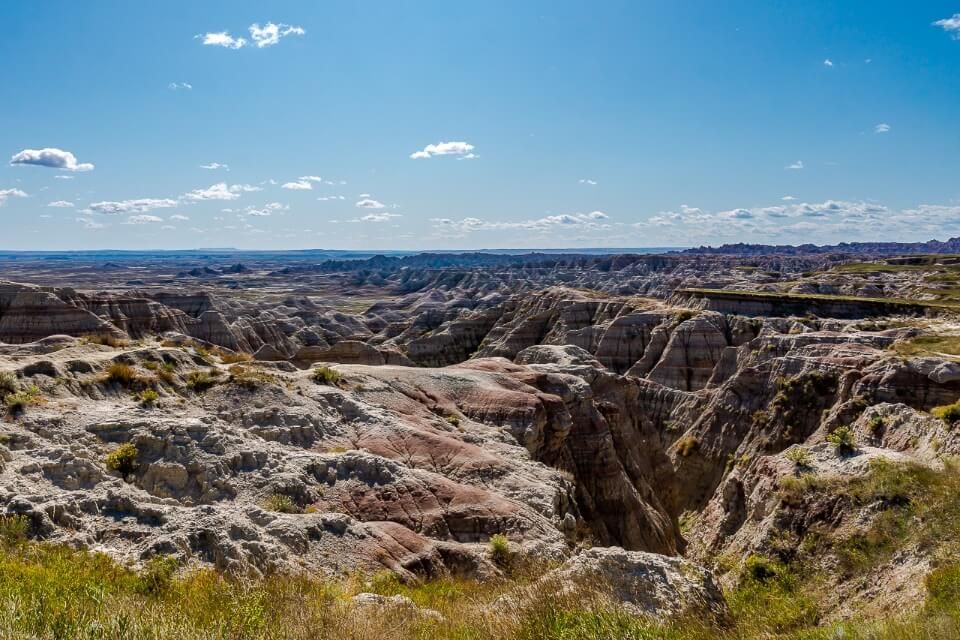 Badlands national park in south dakota with open blue sky and intriguing rocks makes for awesome usa photos