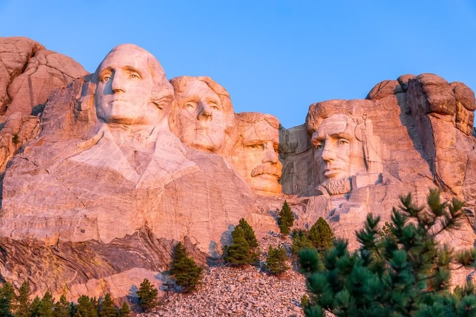 Mount Rushmore illuminate pink as the first rays of sunlight hit the granite structure famous pictures of america