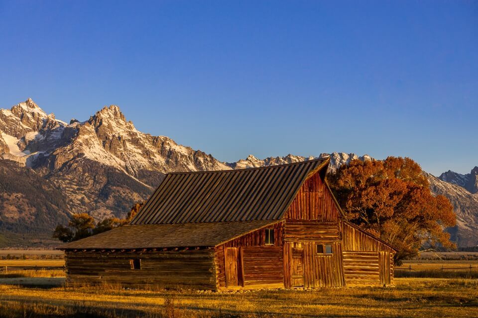 TA Moulton barn mormon row grand teton national park wyoming is one of the most photographed pictures of america amazing scenery photo opportunities with mountains in background at sunrise
