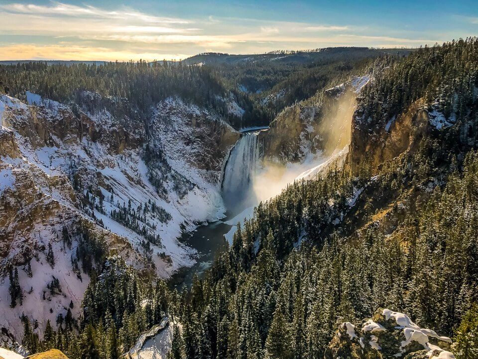 Yellowstone falls waterfall and grand canyon of the yellowstone in snow and ice cold but sunny weather famous pictures of america