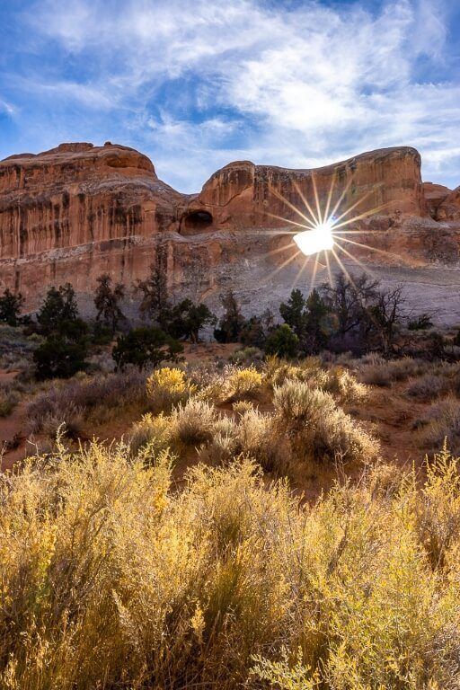 Tunnel Arch along devil's garden trail hike in arches national park with amazing starburst