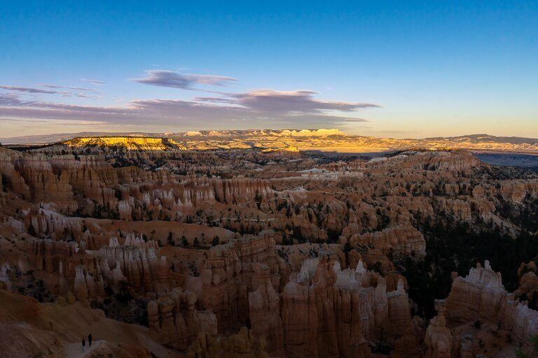 Sunset at bryce canyon photography interesting as shadows on hoodoos below with yellow sun lighting up distant hills