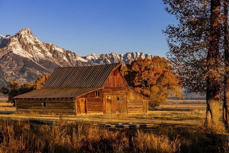 Barn in the sun with shadows and mountains