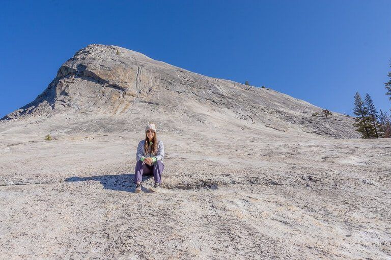 Kristen half way up Lembert Dome steep side face in yosemite national park california on a bright day mark taking photograph
