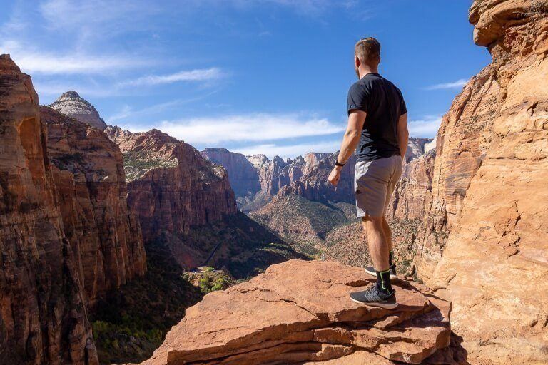 Mark stood on the edge of a cliff with an impressive view in utah