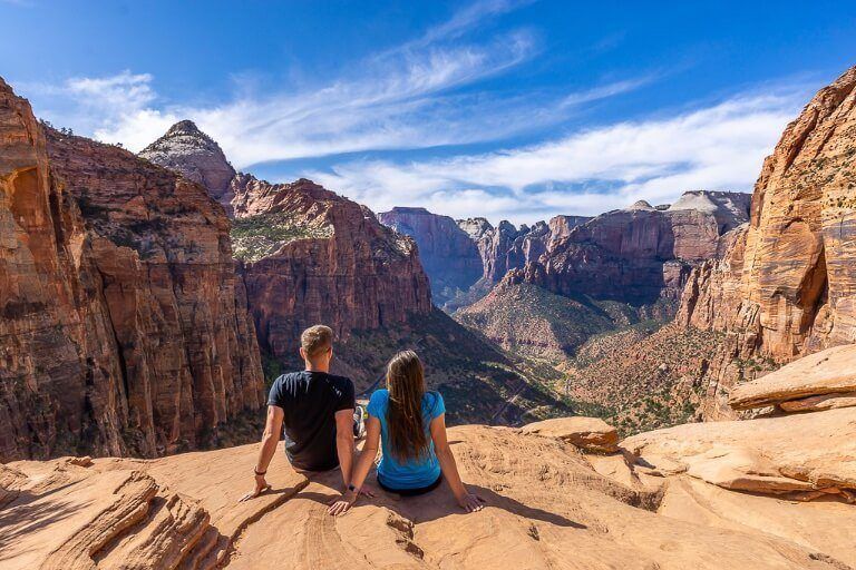 Zion Canyon Overlook viewpoint in the middle of the day on a sunny day in zion national park two hikers enjoying the view