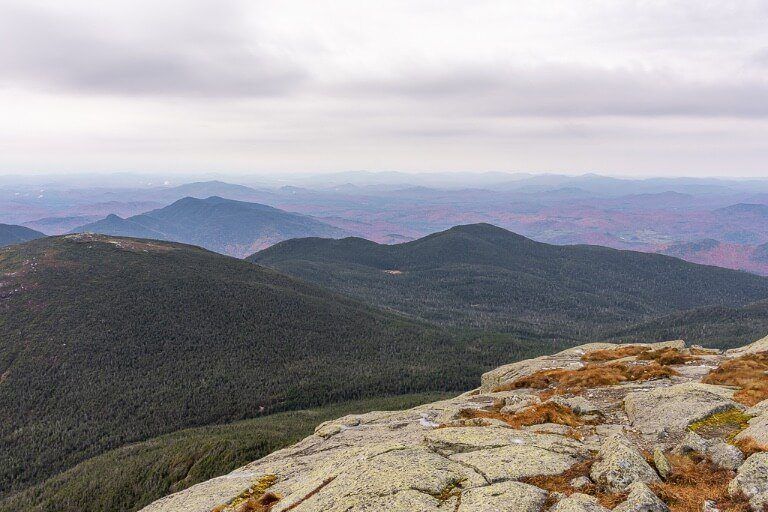 Fall foliage colors just about visible among the grey misty clouds from the top of adirondack mountains ny