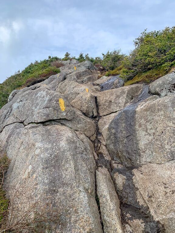 Exposed boulders with climbing sections steep ascent to high peaks in adirondacks