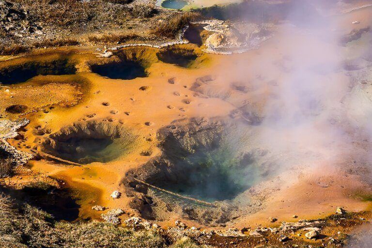Hot Springs orange vibrant color artist paint pot near norris geyser basin