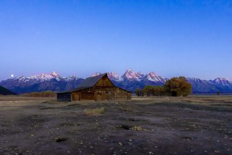 Mormon Row with teton range glowing red at first light