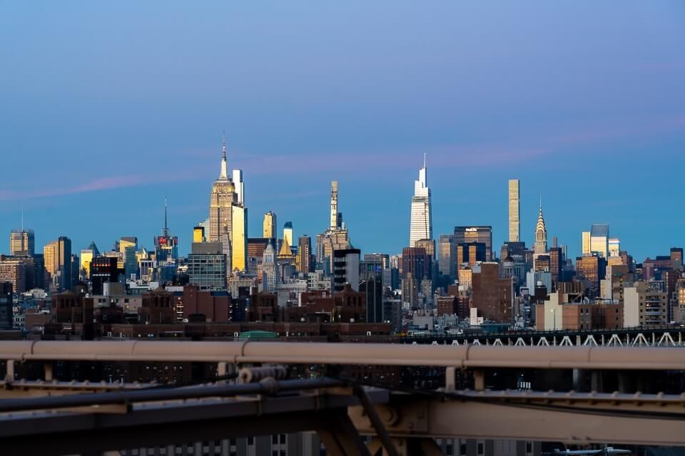 Midtown manhattan and empire state building at dusk with blue and purple sky during sunset