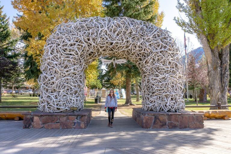 Woman underneath antler arch in Jackson wyoming
