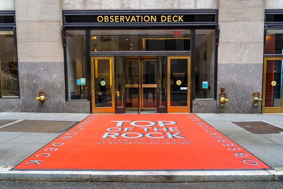 Red carpet entrance with ornate revolving doors top of the rock