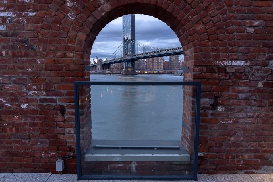 Manhattan Bridge through a window in Time Out Market New York City